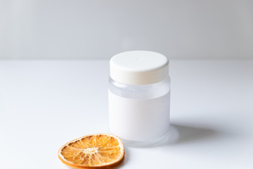 Cosmetic bottle for liquid, cream, gel, lotion. Hand sanitizer. Organic natural science beauty product. Battle with slice of orange