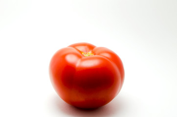 Whole red tomato photo on a white background