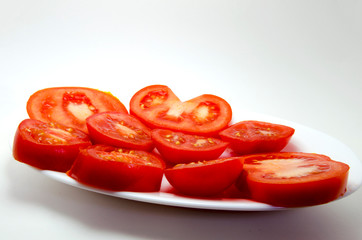 Sliced tomatoes on a white plate photo on a white background
