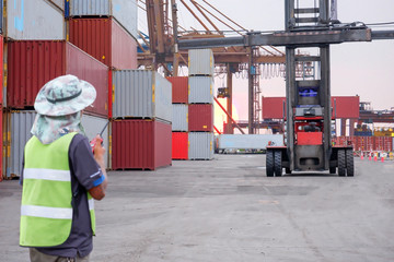 Supervisor Loading container trucks for the background Export Import Logistics Logistics Business concepts Import and export concepts