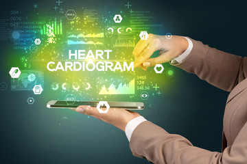 Close-up of a touchscreen with HEART CARDIOGRAM inscription, medical concept