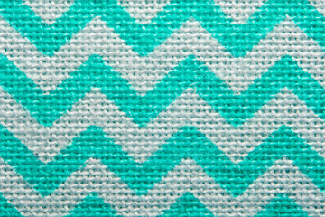Pattern of blue and white striped zig zag. Macro textile texture
