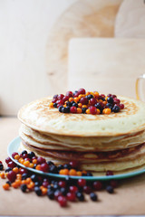 Pancake cake with berries on  table