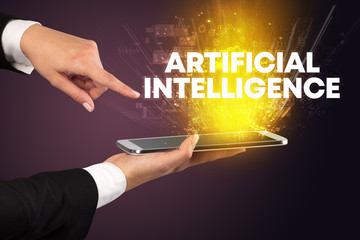 Close-up of a touchscreen with ARTIFICIAL INTELLIGENCE inscription, innovative technology concept