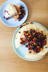 Pancake cake with berries on  table