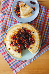 Pancake cake with berries on  table