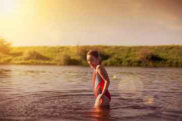   Teen girl  swimming in   warm river.