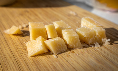 Summertime outside with a plate of Parmezan cheese