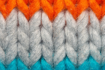 Colorful knit sweater texture macro. Empty copy space background with saturated sweater. Hobby...