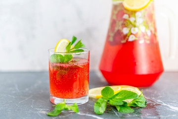 homemade lemonade with strawberries, mint and lemon, jug and glass with summer refreshing cocktail