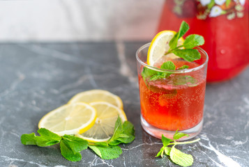 homemade lemonade with strawberries, mint and lemon, jug and glass with summer refreshing cocktail