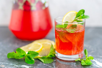 homemade lemonade with strawberries, mint and lemon, jug and glass with summer refreshing cocktail