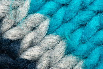 Colorful knit sweater texture macro. Empty copy space background with saturated sweater. Hobby background