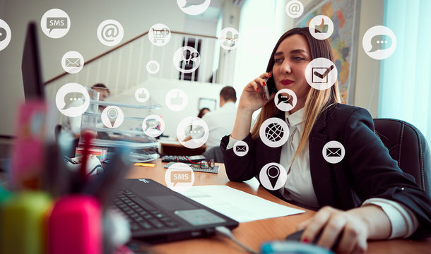 A group of people discuss sitting at a table in the office. Around icons with cloud technology, internet, thumbs up, digital marketing, shopping cart with plus sign, social networks, GPS