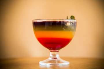 Sweet multi-colored fruit puff jelly in a glass cup