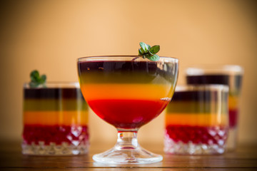 Sweet multi-colored fruit puff jelly in a glass cup