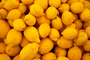 fresh rural lemons with defects are laid out on the counter in the farm organic produce market. Copy, space