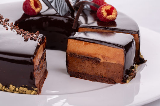 Cut cake with berries, chocolate, berry filling, cows with cream