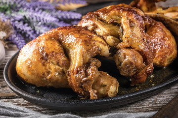 Quarters of fried chicken in a cast iron skillet.