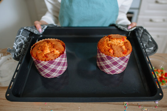 The Cook Is Holding A Baking Tray With Easter Cakes