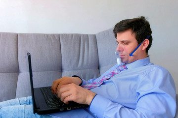 Man working at home on laptop preathing woth help of in oxygen mask, breath problems, coronavirus....