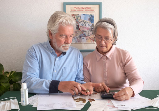 Elderly wife and husband at home are facing household expenses and are concerned about the negative effect of Covid-19 on the economy - Powered by Adobe