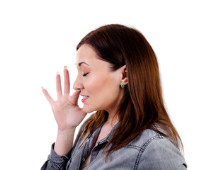 Fototapeta premium Young woman sneezes on a white background