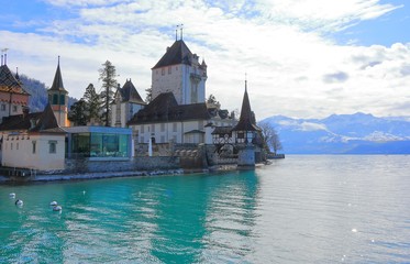 Oberhofen Castle from Lake Thun. Oberhofen town is located on the northern shore of Lake Thun....
