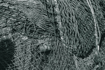 black and white photo old fishing net tangled and piled