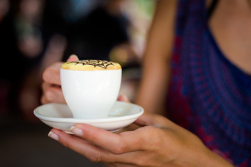Traditional vietnamese egg coffee in hand