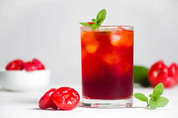 Red cocktail with wax apple lime and mint 