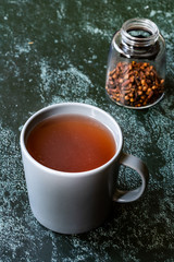Sumac water or tea and dried ground red Sumac spices with cloves in glass.