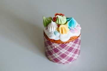 Easter cake with sweet figures on the glaze, standing on the light kitchen table