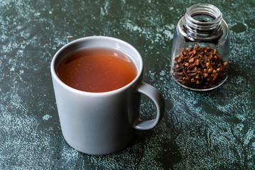 Sumac water or tea and dried ground red Sumac spices with cloves in glass.