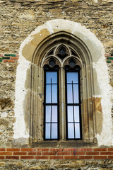 Window in gothic style. Vintage window. Brick wall.