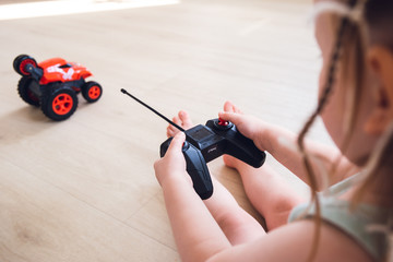 child plays with a remote control car 