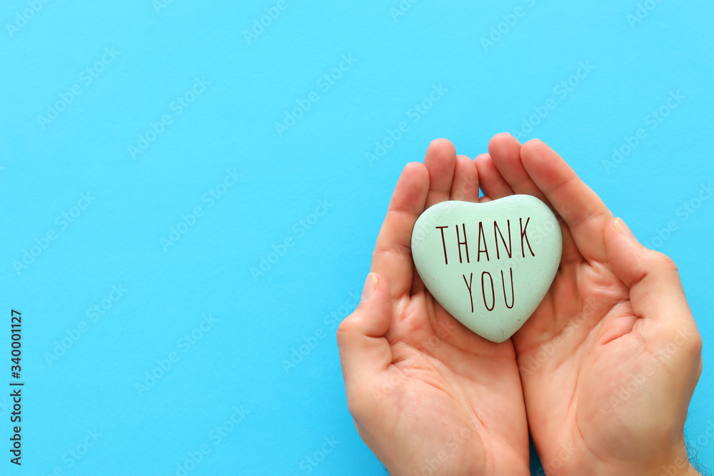 Wall mural top view image holding heart with the text thank you - Wall murals