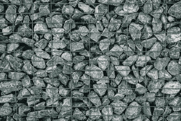 fencing made of gray stone and iron grating