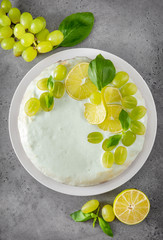 cake  with grapes, lime slices,  green Basil on a gray background, baking,  pie, top view, citrus