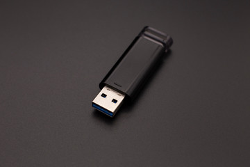 black flash drive on a dark background