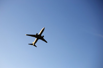 Airplane on a background of blue sky. The plane is landing. The plane takes off.