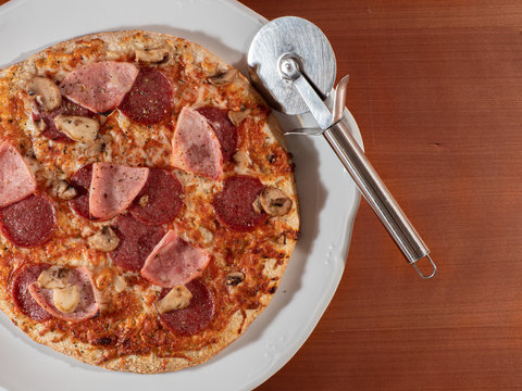 Homemade Pizza On White Plate And Wooden Background Overhead View