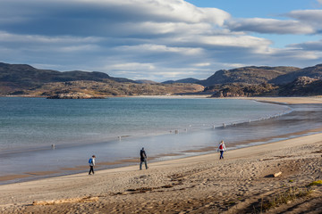 group of tourists walking along the coast of the Barents Sea.