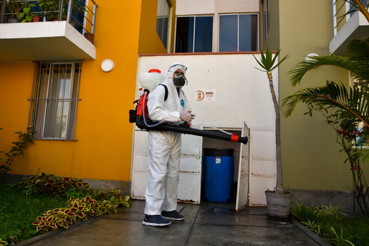 fumigator wearing medical protective clothing to prevent the spread of coronavirus in the houses,Lima-Peru