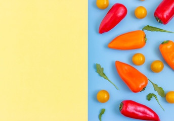 Set fresh vegetables, pepper, tomatoes on blue yellow background. Healthy food concept. Flat lay, top view. Copy space for text