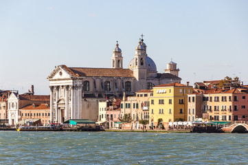 Fototapeta na wymiar Water channels of Venice city. Fondamenta delle Zattere ai Gesuati church on Grand Canal in Venice, Italy.