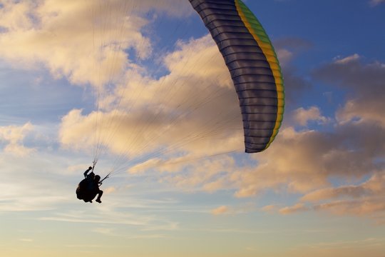 Tandem Paragliding Flying Alone In Sunset Sky