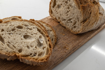 freshly cut homemade bread on a wooden board.
