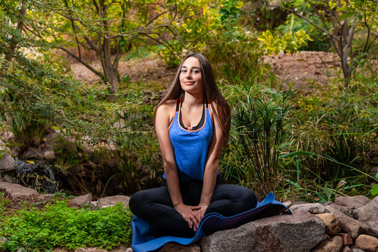 Young woman practicing yoga in the parck