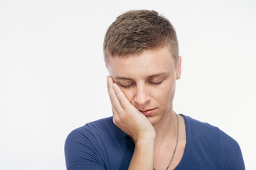 Fototapeta premium Sad young man covered his face with his hand